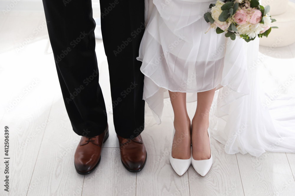 Bride and groom wearing elegant classic wedding shoes indoors, closeup