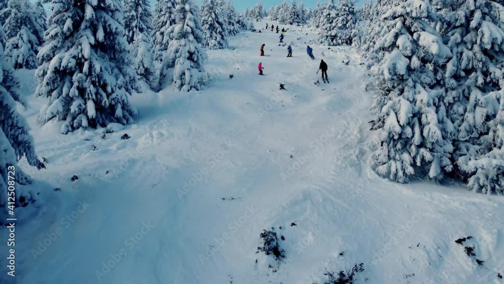 Aerial view. Freerider skiers on top of the mountain. Fresh powder. Extreme freeride skiers skiing from the top. Aerial view. Freerider skiers on top of the mountain. Fresh powder. Extreme freeride skiers skiing from the top.