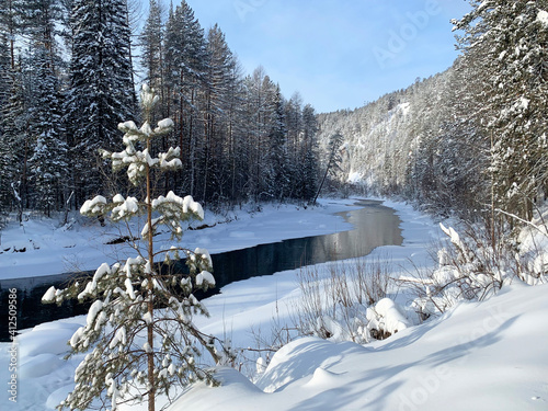 Ivdel river in the Sverdlovsk region in winter in sunny day. Russia