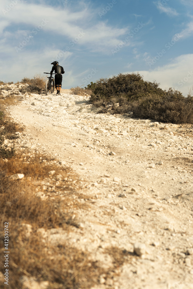 Rider fully equipped with protective gear during downhill ride on his bicycle