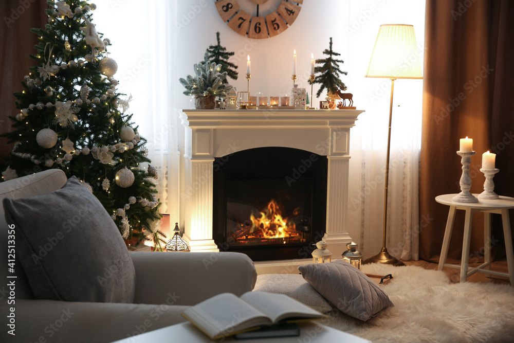 Beautiful room interior with small firs, fireplace and decorated Christmas tree Beautiful room interior with small firs, fireplace and decorated Christmas tree