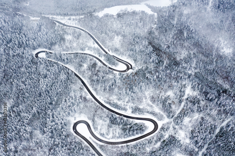 Winter snow winding road Serpentine Switchbacks forest woods season aerial photo view
