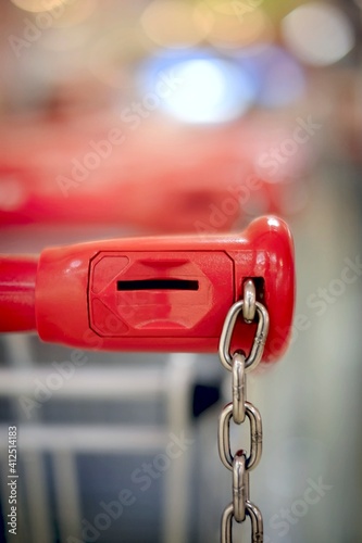 Closeup of a shopping trolley locking system. Vertical image with soft focus. 
