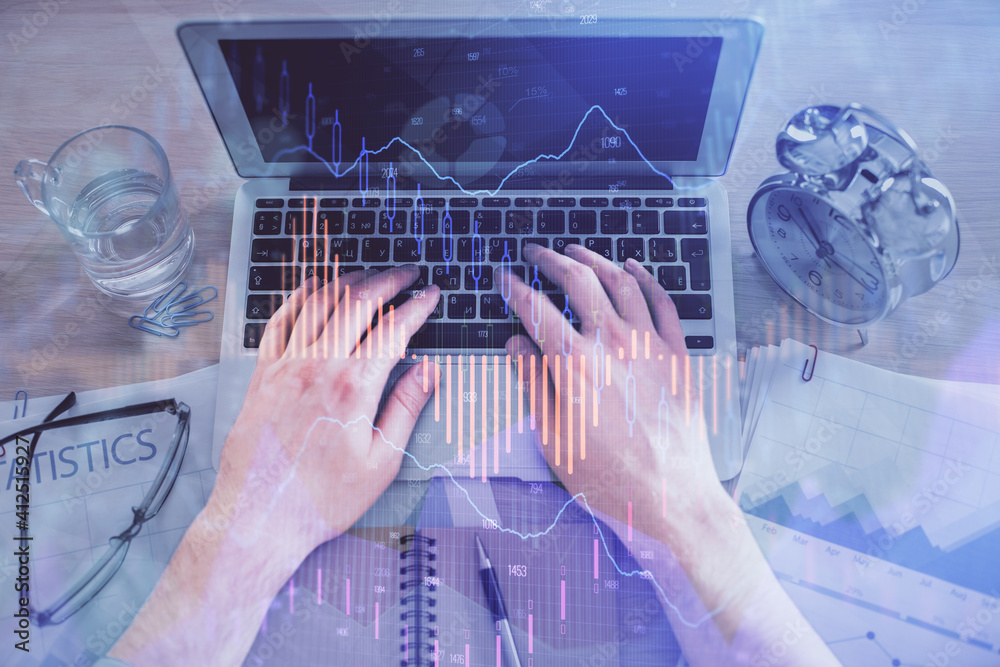Multi exposure of man's hands typing over computer keyboard and forex graph hologram drawing. Top view. Financial markets concept. Multi exposure of man's hands typing over computer keyboard and forex graph hologram drawing. Top view. Financial markets concept.