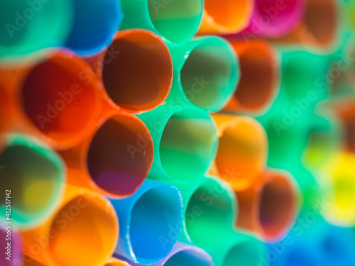 Background of colorful disposable plastic straws close up. Macro details. Environment concept