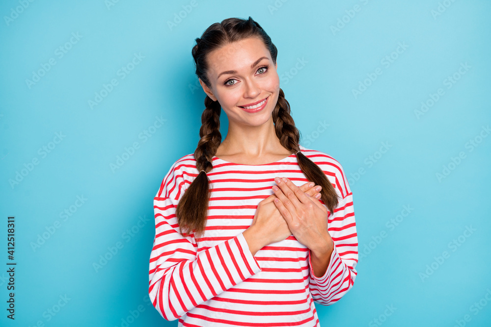 Photo of sweet calm young lady wear red shirt two arms heart chest isolated pastel blue color background Photo of sweet calm young lady wear red shirt two arms heart chest isolated pastel blue color background