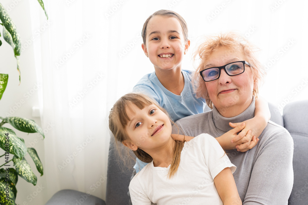 Elderly woman with her little granddaughters