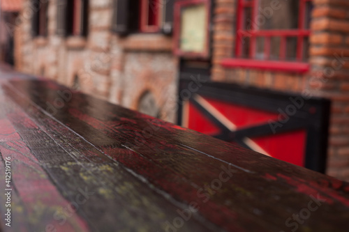 Old wooden table and blurred restaurant on the background, blurred background. 