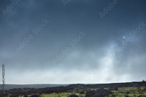 Obraz na plátně With mist shrouded sun, looking north across heather moorland in Yorkshire