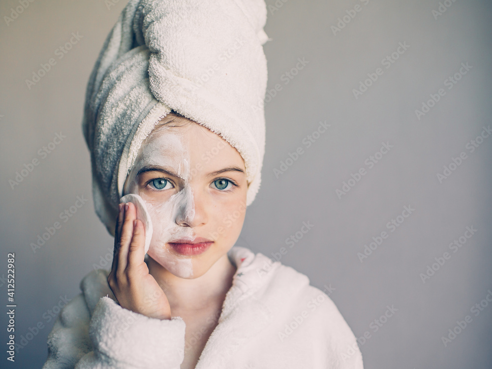 Funny young girl with a mask for skin face