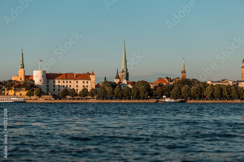 Riga old town in Latvia, Europe, view from the water in summer, golden hour