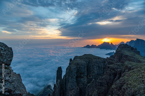 Dramatic sunrise with layers of cloud and sunbeams from high up in the Drakensberg mountains.