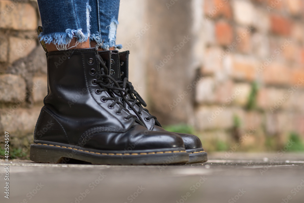 Rome, Italy - January 22, 2021: Classic black leather Dr. Martens AirWair  boots. Dr Martens is an English footwear, accessories and clothing brand  Stock Photo | Adobe Stock
