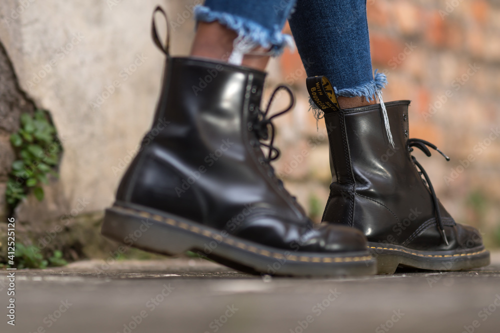 Rome, Italy - January 22, 2021: Classic black leather Dr. Martens AirWair  boots. Dr Martens is an English footwear, accessories and clothing brand  Stock Photo | Adobe Stock
