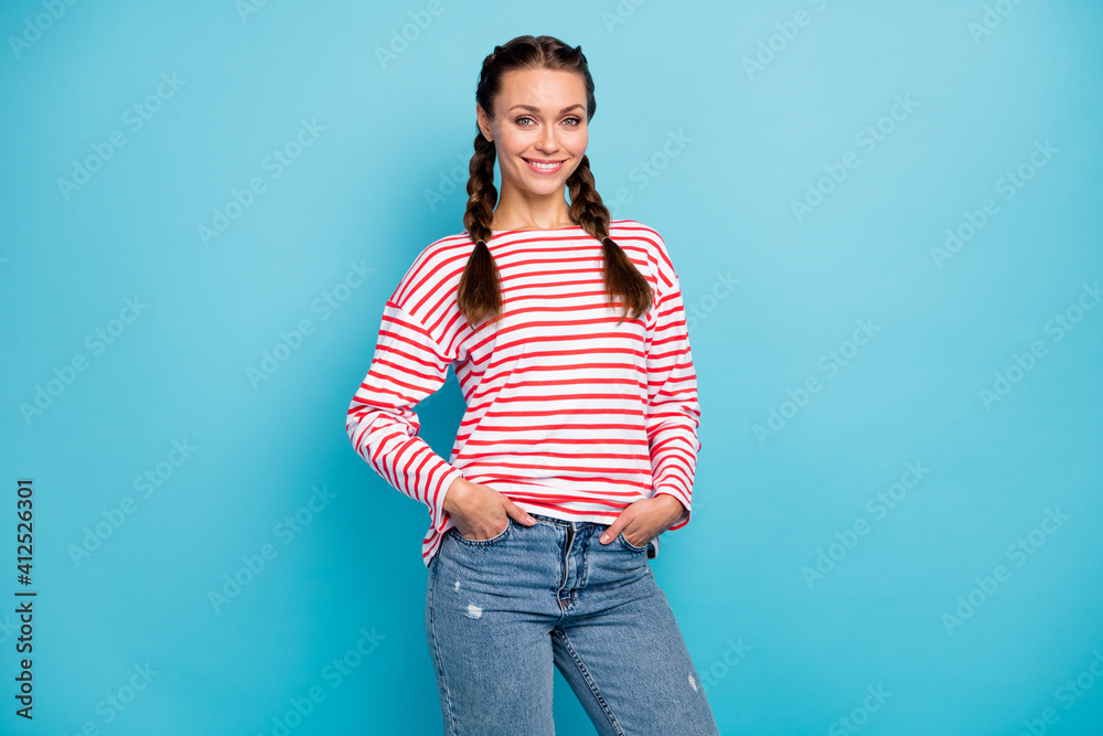 Photo of adorable sweet young woman dressed striped shirt smiling arms pockets isolated blue color background Photo of adorable sweet young woman dressed striped shirt smiling arms pockets isolated blue color background