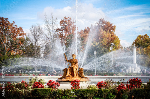 Fountain of Ceres in the Parterre Garden, Aranjuez, Spain. Sunny day, splashing water over blooming flower beds