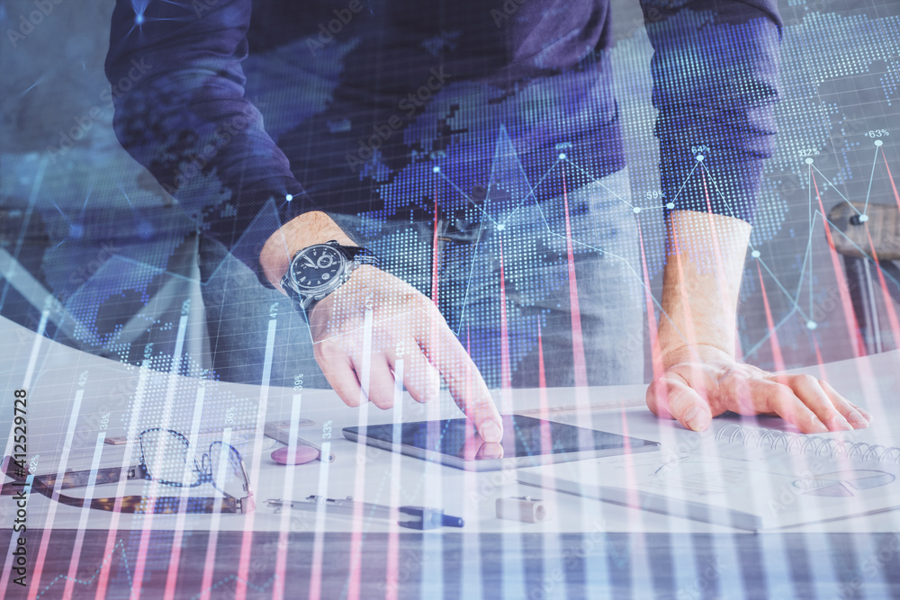 Double exposure of man's hands holding and using a digital device and forex graph drawing. Financial market concept. Double exposure of man's hands holding and using a digital device and forex graph drawing. Financial market concept.