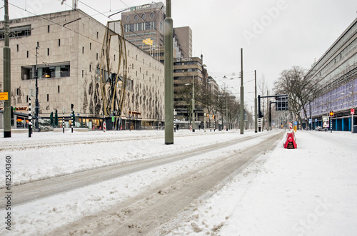 Rotterdam, The Netherlands, February 7, 2021: Coolsingel boulevard covered in freshly fallen snow on a cold day in winter photo