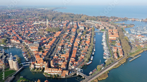 Aerial drone photo of the beautiful historic city of Enkhuizen, with old town marina harbors in the Netherlands
