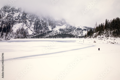 Wallpaper Mural Romantic couple on a frozen lake in a snowy mountain landscape Torontodigital.ca