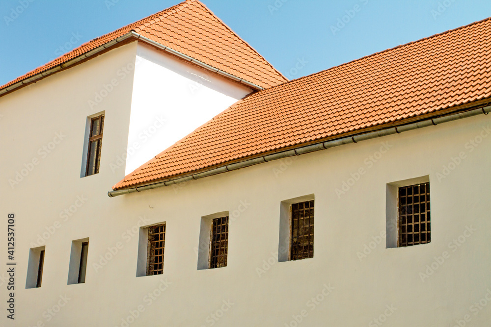 red tile roof on an old house with latticed windows