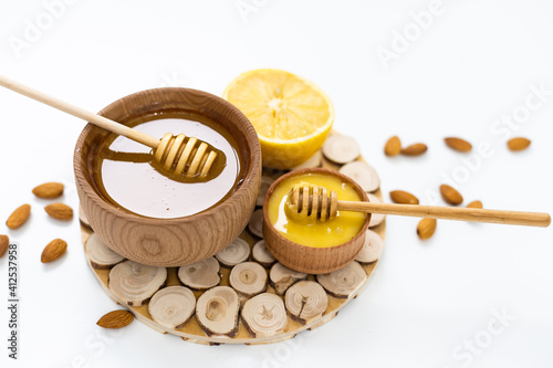 Bowl of honey on white background. Symbol of healthy living and natural medicine. Aromatic and tasty.