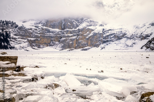 Wallpaper Mural Broken ice on the edge of a frozen lake in a snowy mountain landscape Torontodigital.ca