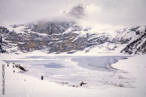 Wallpaper Mural People spending day by frozen lake in snowy mountain landscape Torontodigital.ca