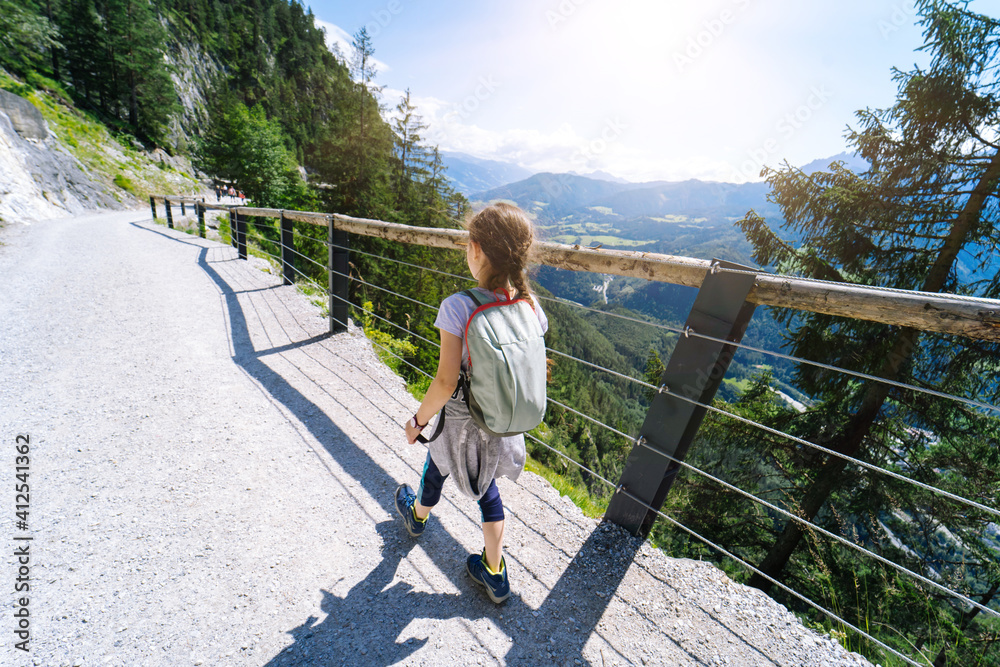 Children hiking on beautiful summer day in alps mountains Austria, resting on rock and admire amazing view to mountain peaks. Active family vacation leisure with kids. Outdoor fun and healthy activity Children hiking on beautiful summer day in alps mountains Austria, resting on rock and admire amazing view to mountain peaks. Active family vacation leisure with kids. Outdoor fun and healthy activity