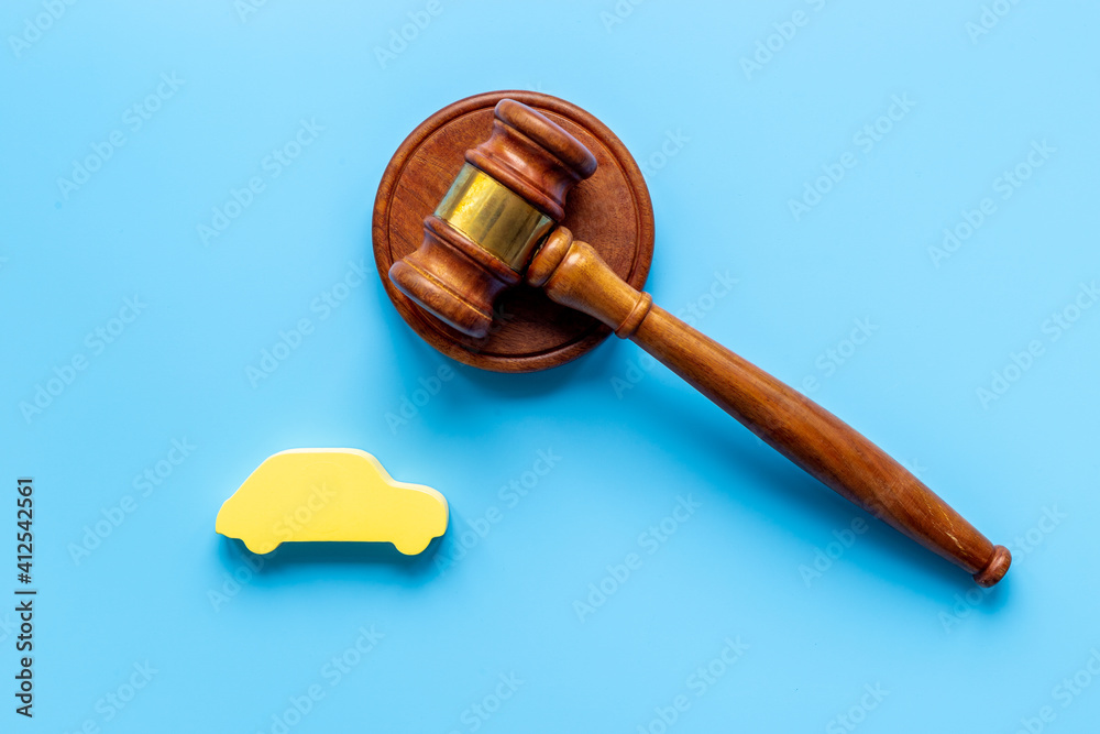 Car shape with judge gavel. Driving and insurance law concept