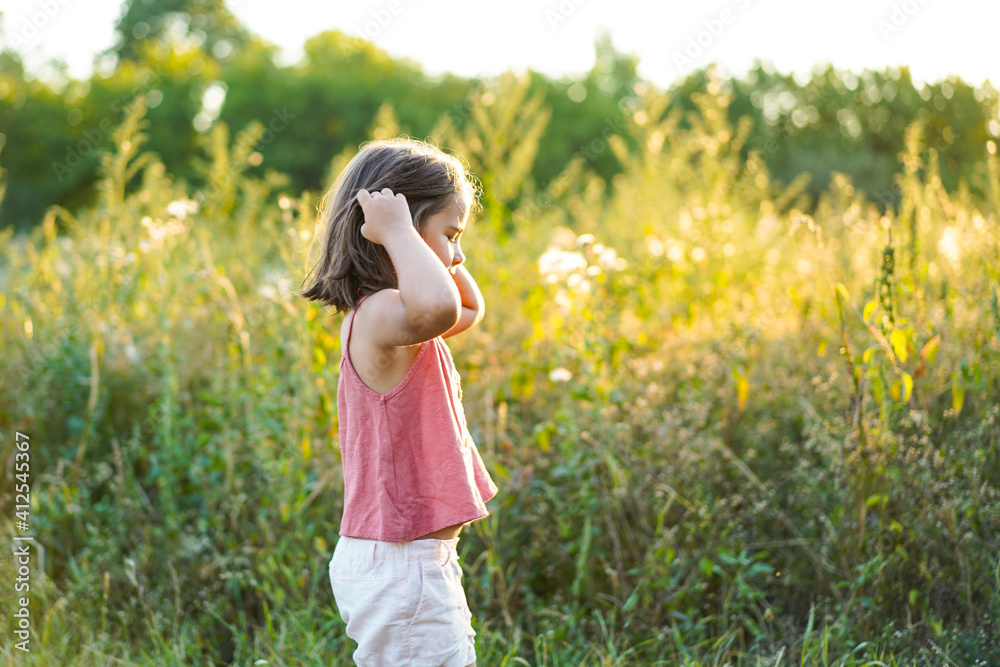 Portrait of a little girl with flowers in the field Portrait of a little girl with flowers in the field