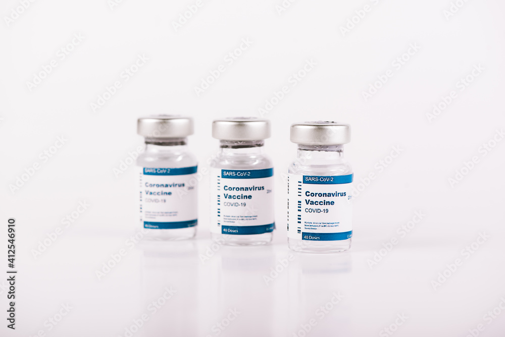 three Covid-19 vaccine vials with white background three Covid-19 vaccine vials with white background