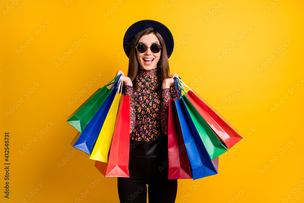 Photo of astonished lady hold bags open mouth cheap price vintage cap isolated on yellow color background