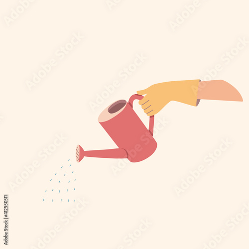 A gloved hand holds a watering can. The element of gardening in red and yellow.