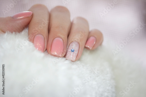 Manicure design with snowflake pattern with ice stone in the middle