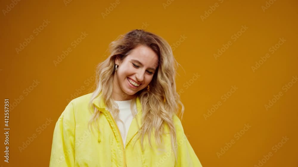 Happy young joyful woman portrait smiling against yellow background Happy young joyful woman portrait smiling against yellow background