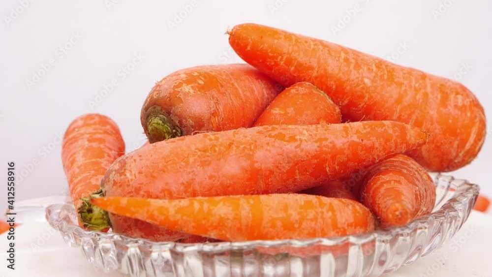 Close rotating shot of orange carrots in a glass bowl, View of carrots in a glass bowl Close rotating shot of orange carrots in a glass bowl, View of carrots in a glass bowl