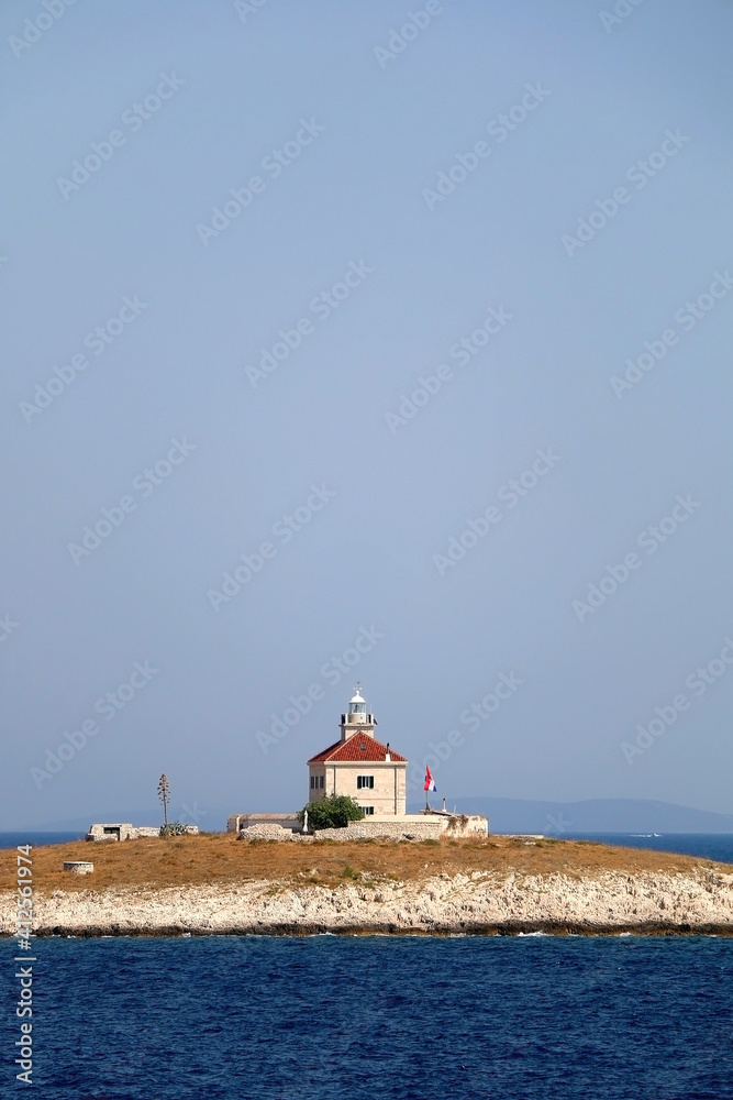 Picturesque lighthouse on small island near Hvar, Croatia. Picturesque lighthouse on small island near Hvar, Croatia.