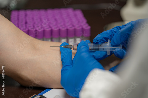 The patient is vaccinated to prevent the corona virus flu.The nurse who injected wear the PVE suite to prevent the infection. photo