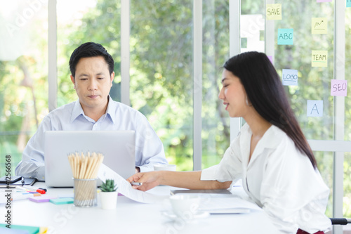 Asian business people manager talking in meeting with laptop on table work room planning.