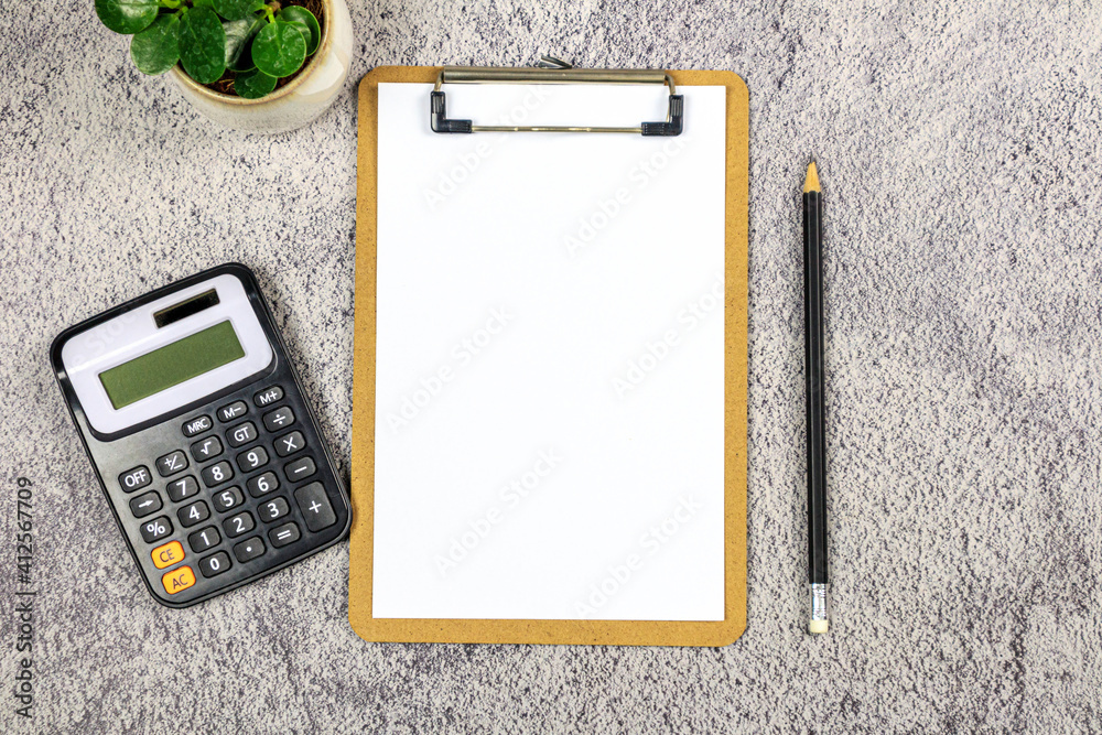 A notebook with pencil and calculator on the desk. - Business concept. A notebook with pencil and calculator on the desk. - Business concept.