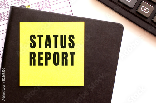 STATUS REPORT text on a sticker on your desktop. Diary and calculator.