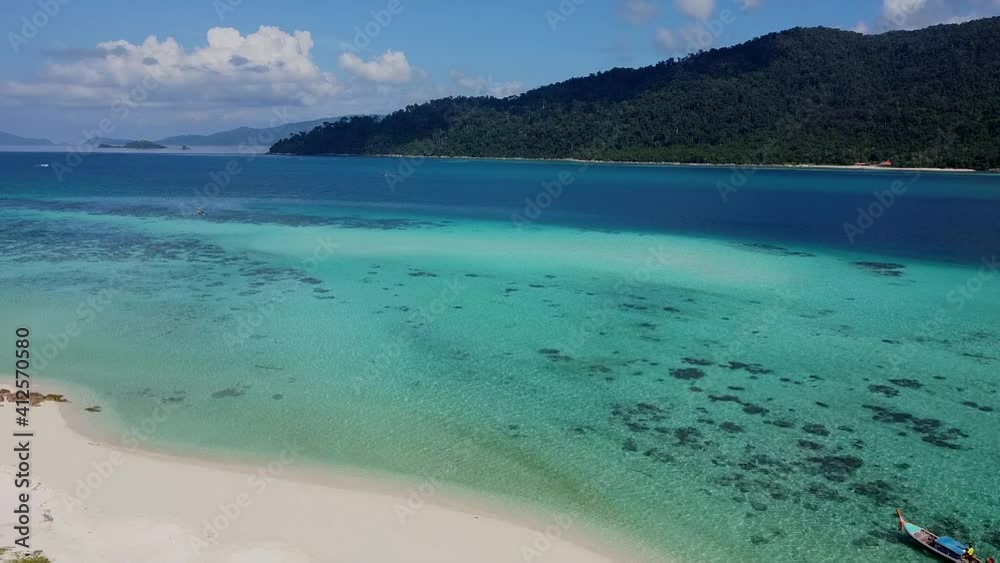 Aerial Top View on Beautiful Blue Ocean Beach with White Sand and Longtail Boat. Drone Shot of Landscape with Sea Water at Tropical Island. Birds Eye View of Empty Sand Beach in Thailand, Koh Lipe Aerial Top View on Beautiful Blue Ocean Beach with White Sand and Longtail Boat. Drone Shot of Landscape with Sea Water at Tropical Island. Birds Eye View of Empty Sand Beach in Thailand, Koh Lipe