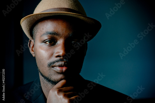 Vintage african man sitting in the dark room , Low key style