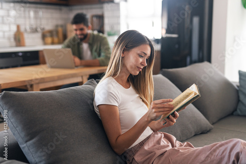 Side view of a stunning women reading a book at home