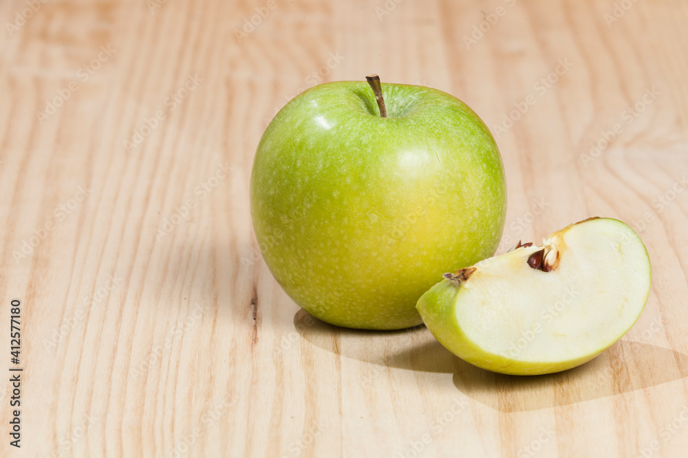 Tasty green apple; photo on wooden background. Tasty green apple; photo on wooden background.