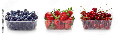 Various berries in plastic container box isolated on white