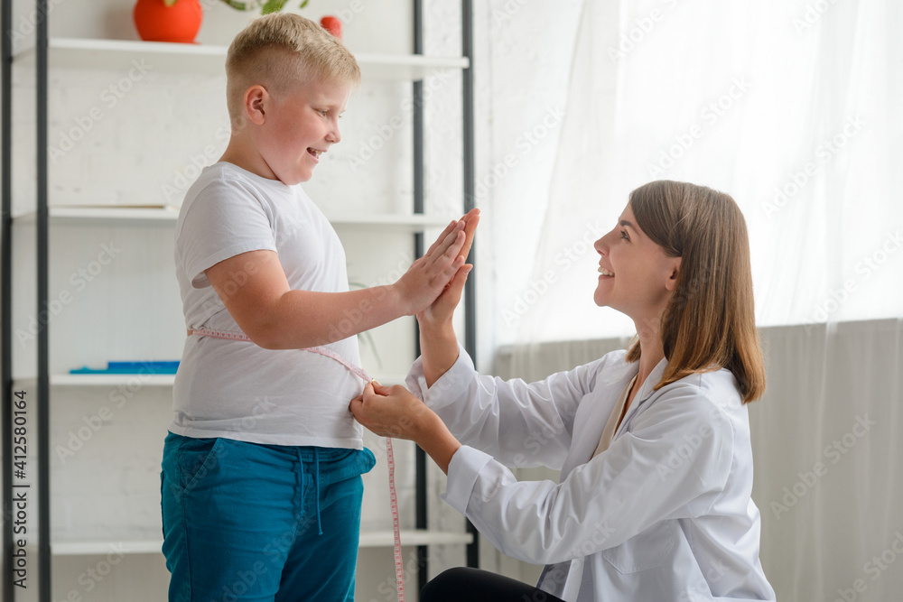 Fototapeta premium Doctor congratulates an obese boy with first good results