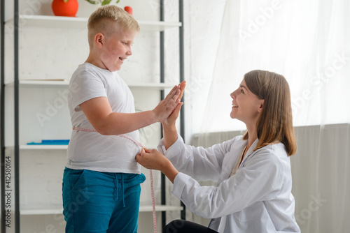 Doctor congratulates an obese boy with first good results