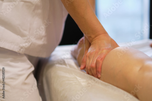 Obraz na płótnie Detail of hands massaging human calf muscle